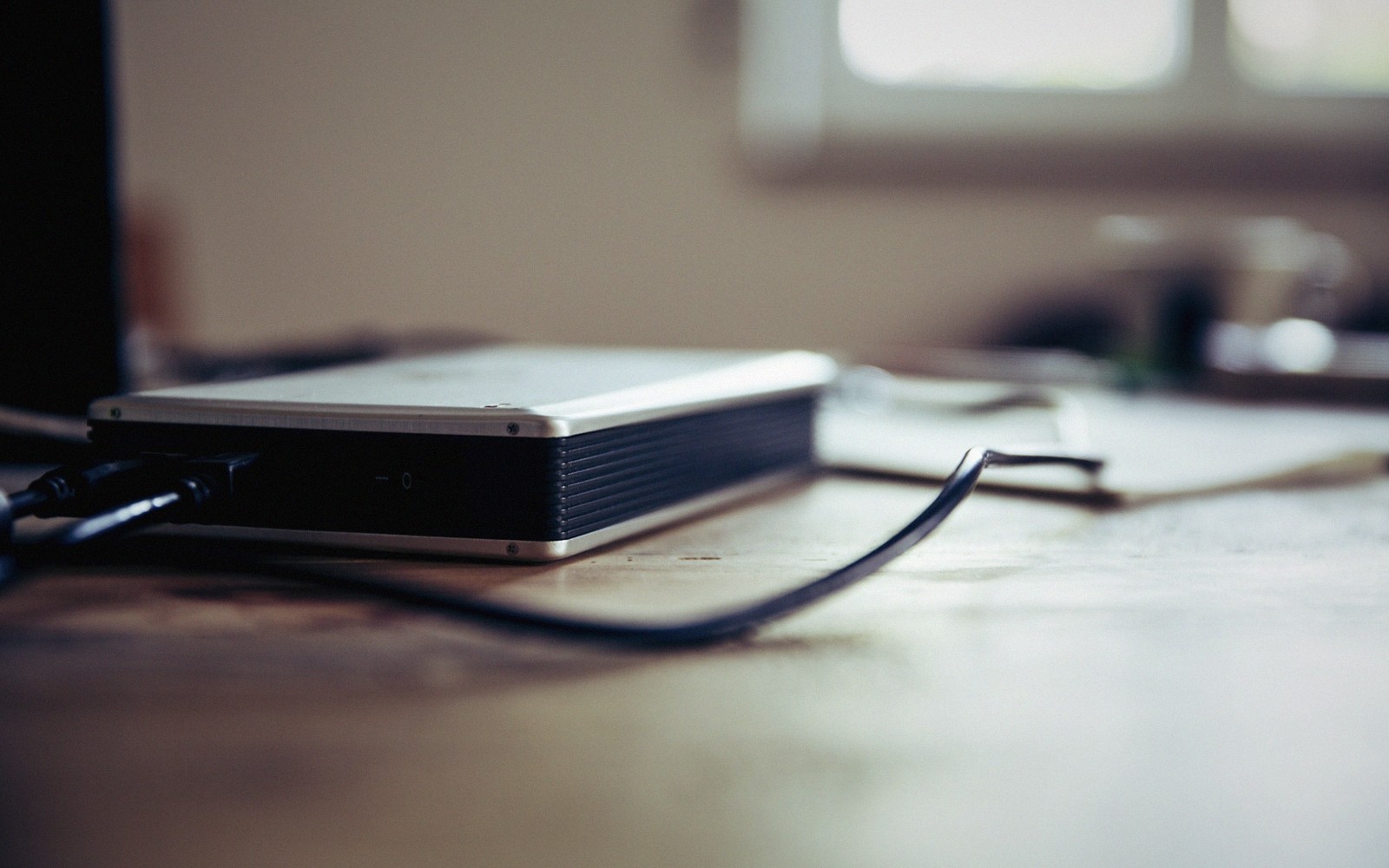 Stack of external hard drives with coiled cables